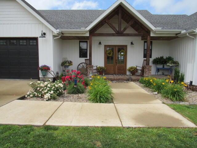 2799-2 Sparks Rd, Norwood, MO 65717 - entrance to property featuring a porch, an attached garage, french doors, and a shingled roof