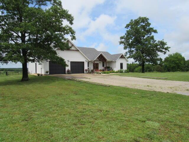 2799-2 Sparks Rd, Norwood, MO 65717 - view of front of property featuring concrete driveway, a garage, and a front lawn
