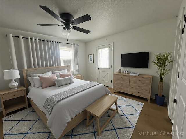 1131 Polk St, Warsaw, MO 65355 - bedroom featuring a textured ceiling, wood finished floors, and a ceiling fan
