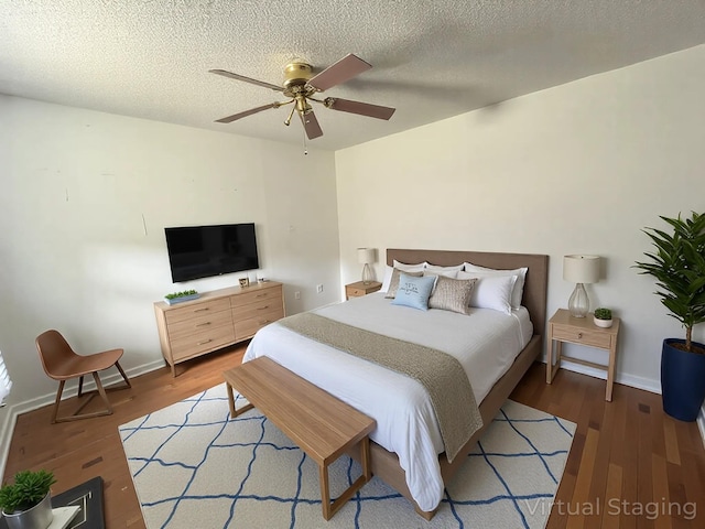 1131 Polk St, Warsaw, MO 65355 - bedroom featuring baseboards, a ceiling fan, wood finished floors, and a textured ceiling