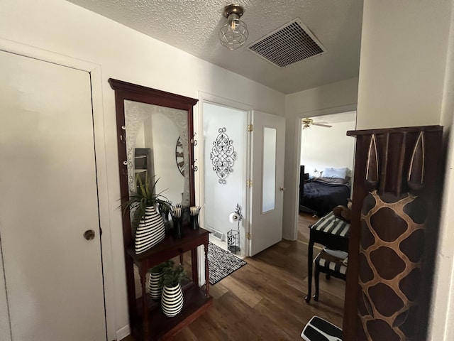 1131 Polk St, Warsaw, MO 65355 - foyer featuring a textured ceiling, dark wood-style floors, and visible vents