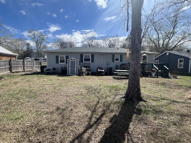 1131 Polk St, Warsaw, MO 65355 - back of house featuring roof with shingles, a yard, a deck, and fence