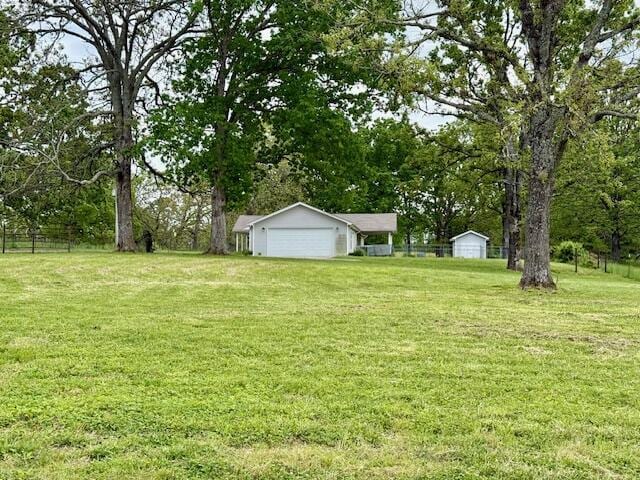 1005 County Road 3030, Mountain View, MO 65548 - view of yard featuring an outbuilding, a garage, and view of scattered trees