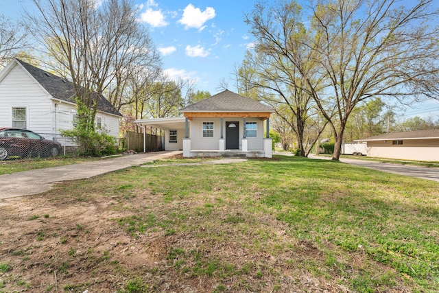 view of front of home with a carport, a front lawn, fence, and concrete driveway