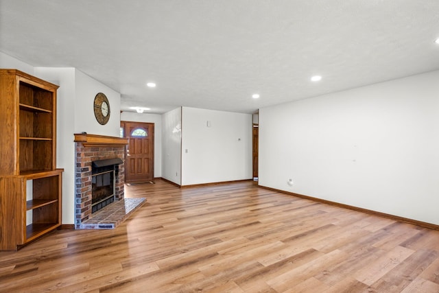 3131 E Southern Hills Blvd, Springfield, MO 65804 - unfurnished living room featuring recessed lighting, light wood-type flooring, a fireplace, and baseboards