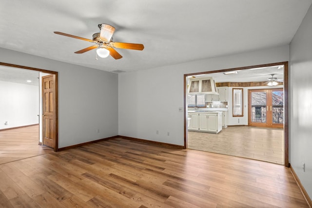 3131 E Southern Hills Blvd, Springfield, MO 65804 - unfurnished room with ceiling fan, light wood-type flooring, and baseboards