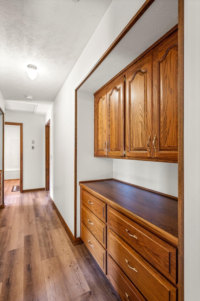 3131 E Southern Hills Blvd, Springfield, MO 65804 - hall with dark wood-style flooring, baseboards, and a textured ceiling