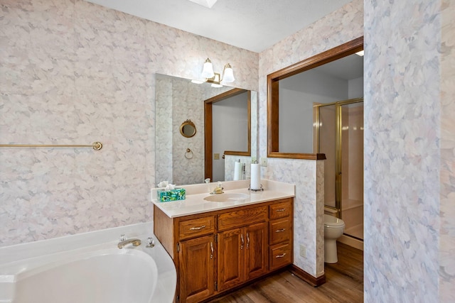 3131 E Southern Hills Blvd, Springfield, MO 65804 - bathroom featuring a shower stall, a garden tub, wallpapered walls, and wood finished floors
