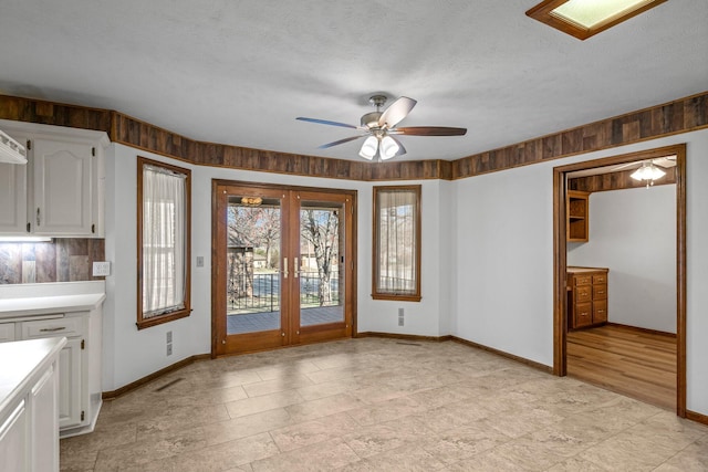 3131 E Southern Hills Blvd, Springfield, MO 65804 - interior space featuring french doors, baseboards, a ceiling fan, and a textured ceiling