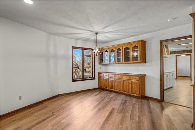 3131 E Southern Hills Blvd, Springfield, MO 65804 - unfurnished dining area featuring baseboards, a notable chandelier, and light wood-style floors