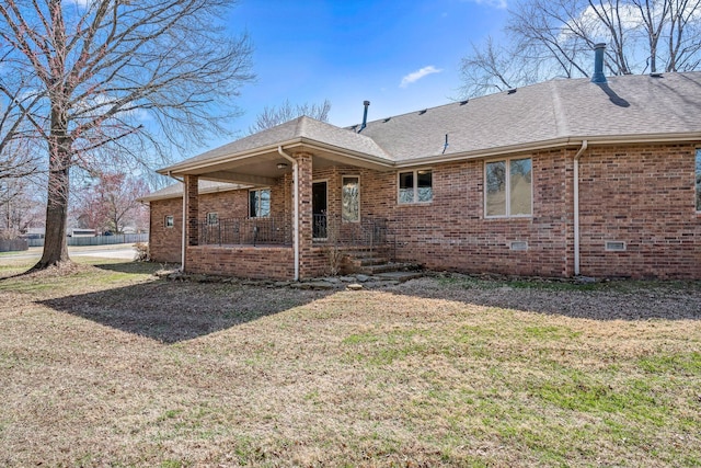 3131 E Southern Hills Blvd, Springfield, MO 65804 - back of house with a porch, roof with shingles, brick siding, and a lawn