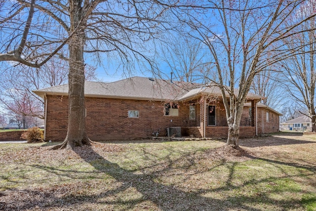 3131 E Southern Hills Blvd, Springfield, MO 65804 - back of house with a yard, brick siding, and central AC unit