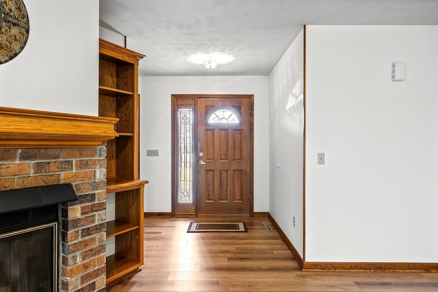 3131 E Southern Hills Blvd, Springfield, MO 65804 - entryway featuring baseboards, a brick fireplace, and wood finished floors