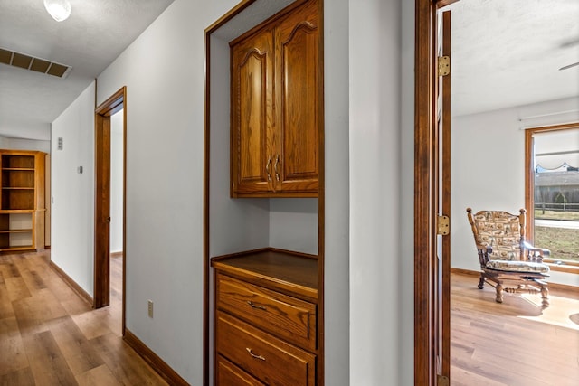 3131 E Southern Hills Blvd, Springfield, MO 65804 - hallway with light wood-style floors, baseboards, and visible vents