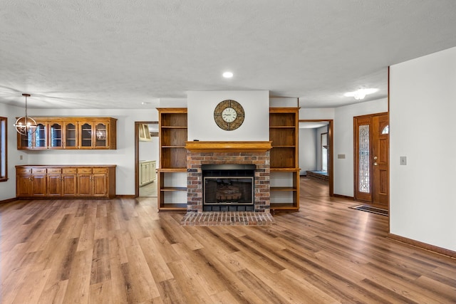 3131 E Southern Hills Blvd, Springfield, MO 65804 - living room with light wood-style flooring, baseboards, a brick fireplace, and recessed lighting
