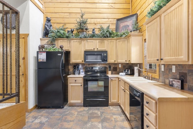kitchen featuring light brown cabinets, a sink, black appliances, and backsplash