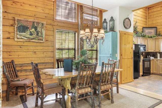 dining area with wooden walls and a chandelier