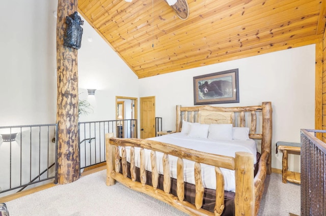 carpeted bedroom with wood ceiling and high vaulted ceiling
