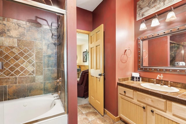 ensuite bathroom with bathing tub / shower combination, vanity, and connected bathroom