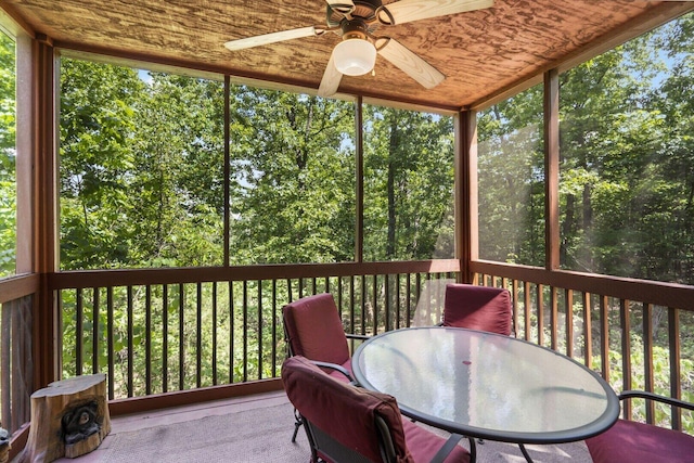 sunroom featuring outdoor dining space and a ceiling fan