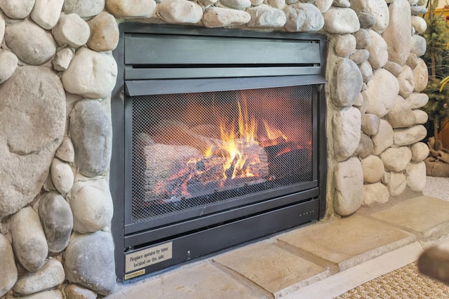 details with a lit fireplace
