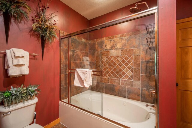 full bathroom with a combined bath / shower with jetted tub, baseboards, and toilet