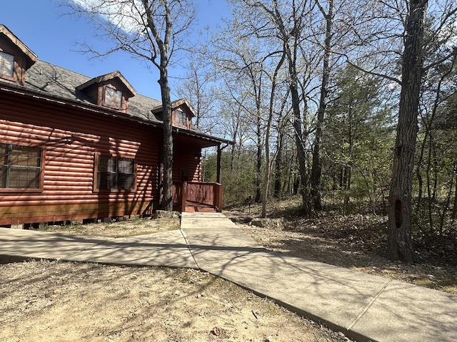 view of property exterior featuring log veneer siding
