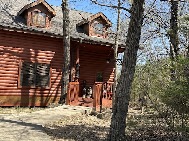 exterior space featuring a shingled roof