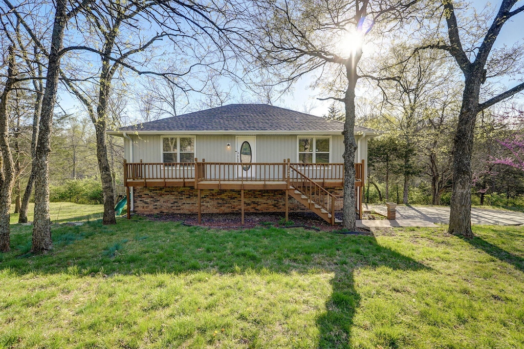 back of house with a yard, stairway, and a wooden deck