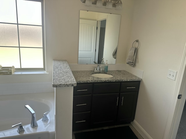 bathroom with vanity and a bath