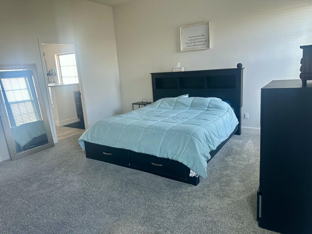 bedroom with baseboards and carpet