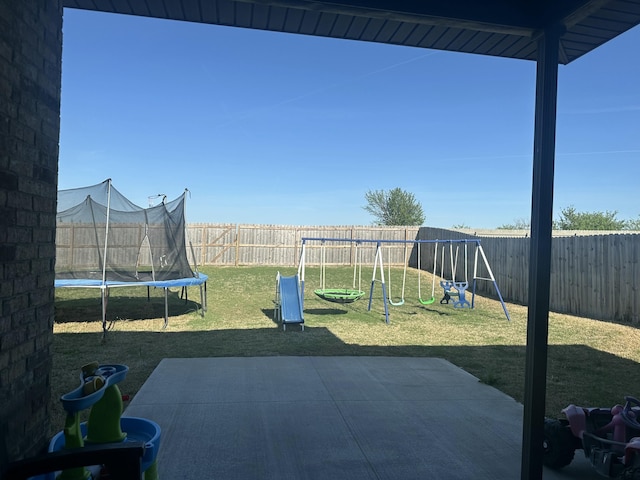 view of yard featuring a playground, a trampoline, a fenced backyard, and a patio