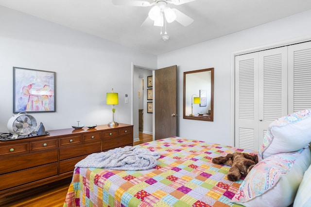 bedroom with a closet, ceiling fan, and wood finished floors
