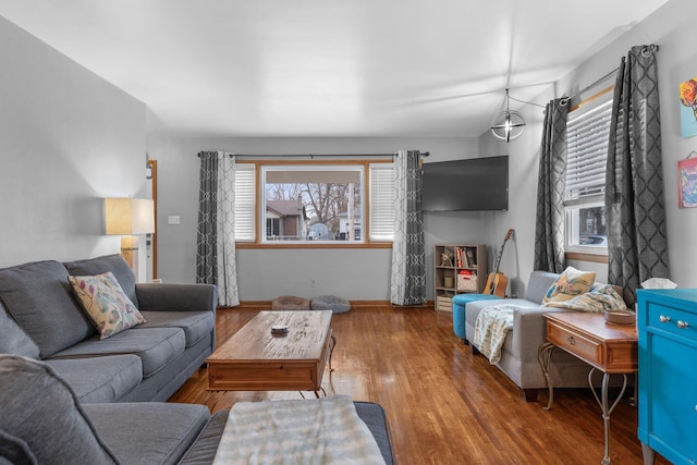 living area featuring baseboards and wood finished floors
