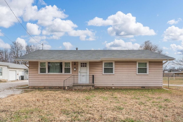 ranch-style home with crawl space, an outbuilding, a front yard, and fence