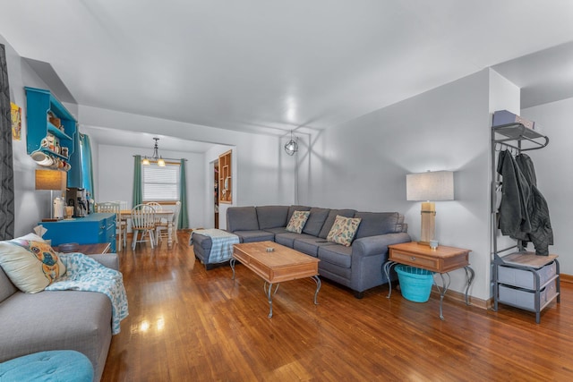 living room with a chandelier and wood finished floors
