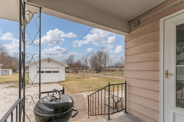 view of patio with an outdoor structure and a detached garage