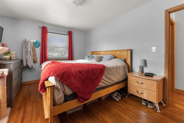 bedroom featuring baseboards and wood finished floors