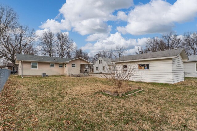 back of house featuring a patio area, cooling unit, fence, and a lawn