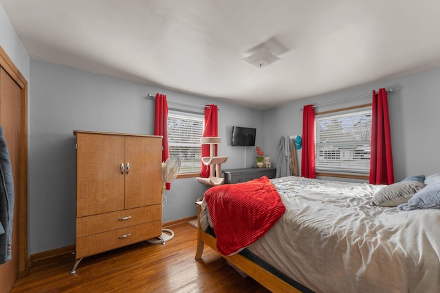 bedroom featuring baseboards and wood finished floors