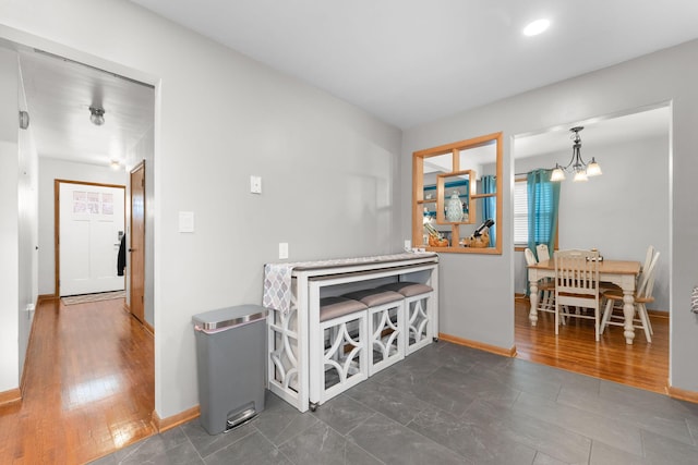dining space with baseboards and a notable chandelier