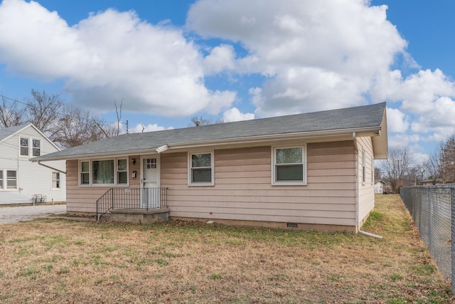 ranch-style house featuring a front lawn, fence, and crawl space