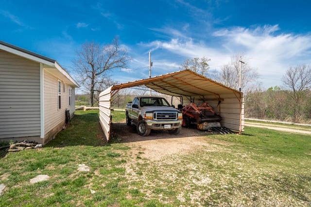 view of parking with a carport and dirt driveway