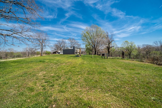 view of yard with an outdoor structure and fence