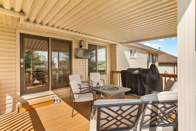deck featuring a fire pit and grilling area