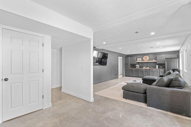 living room with recessed lighting, concrete floors, visible vents, and baseboards