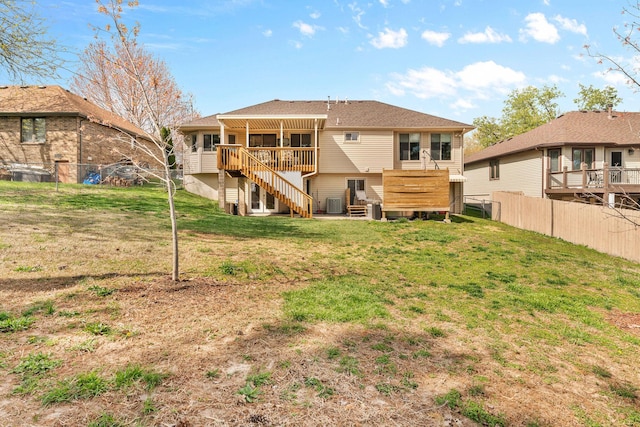 rear view of property featuring stairs, a yard, cooling unit, and fence