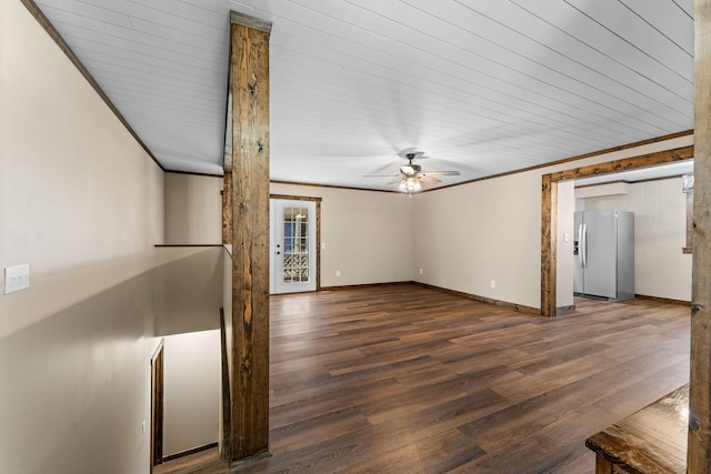 unfurnished living room with wood finished floors, baseboards, crown molding, and ceiling fan