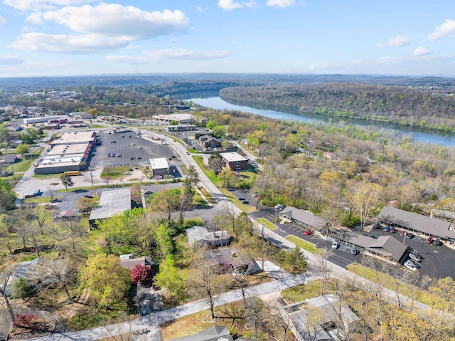 aerial view with a water view and a wooded view