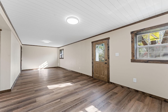 interior space featuring ornamental molding, baseboards, wooden ceiling, and wood finished floors